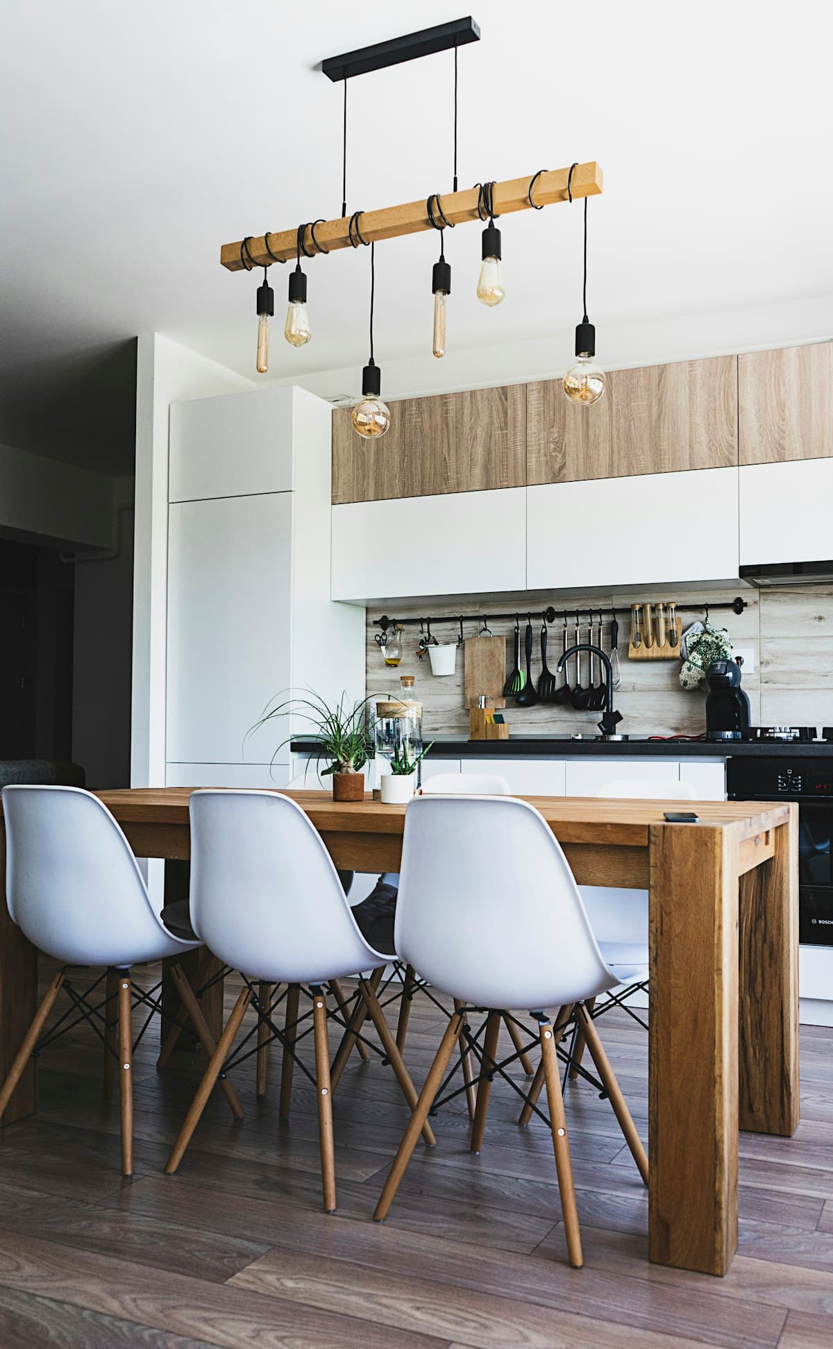 The bright interior of a newly owned home, with a dining table and kitchen